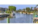 Scenic waterfront view featuring a canal with docks, lush greenery, and beautiful homes in a sunny locale at 4704 Coral Lake Dr, Bradenton, FL 34210
