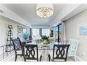 Bright dining area with modern lighting, glass table, and comfortable seating, perfect for entertaining and Gathering meals at 5309 Myrtle Wood Rd # 43, Sarasota, FL 34235