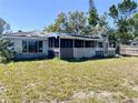 Backyard with a covered, screened porch, and needing some TLC at 6408 2Nd W Ave, Bradenton, FL 34209