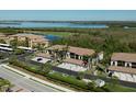 Aerial view showcasing the condo buildings, lush landscaping and water views at 6611 Grand Estuary Trl # 105, Bradenton, FL 34212