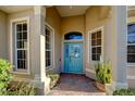 Charming entryway features a decorative glass door, sidelight windows, and brick flooring at 6619 Copper Ridge Trl, Bradenton, FL 34201