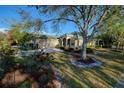 Well-maintained single-story home with lush landscaping and a neatly manicured lawn at 6619 Copper Ridge Trl, Bradenton, FL 34201