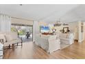 Bright living room with wood floors, sliders to lanai, and comfortable seating area at 6820 19Th W Ave, Bradenton, FL 34209