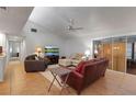 Living room area featuring tile floors, neutral-toned sofas, and a sliding glass door at 6946 Woodwind Dr # 2, Sarasota, FL 34231