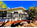 A private backyard space showing a raised concrete patio area with a black fence and mature trees at 7314 Mauna Loa Blvd, Sarasota, FL 34241