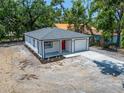 Charming one-story home featuring a covered porch, freshly laid sod, and a driveway at 732 15Th E St, Bradenton, FL 34208