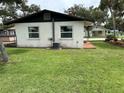 A well-maintained single-story home with a chain link fence, and a green lawn at 775 Liberty St, Englewood, FL 34223