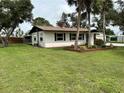 A well-maintained single-story home with a green lawn, enhancing its curb appeal at 775 Liberty St, Englewood, FL 34223