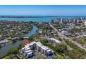 Stunning aerial view showcases condo complex, waterway access, and scenic cityscape backdrop at 835 S Osprey Ave # 415, Sarasota, FL 34236