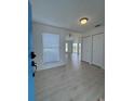 Bright entryway with wood-look floors, white walls, ample storage, and a glimpse of the water view at 859 Audubon Dr # 859, Bradenton, FL 34209