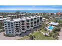 Exterior angle showing the building with a pool and hot tub, along with an approximate unit location at 8735 Midnight Pass Rd # 306B, Sarasota, FL 34242