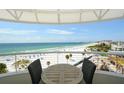 Balcony view of the beach, with seating, and a sunny sky at 915 Seaside Dr # 613 Weeks 32-33, Sarasota, FL 34242