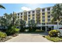 Multi-story building exterior with balconies, tropical landscaping, and covered entrance at 915 Seaside Dr # 613 Weeks 32-33, Sarasota, FL 34242