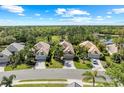 Beautiful aerial view of several homes with lush green lawns near a serene lake at 11716 Strandhill Ct, Lakewood Ranch, FL 34202