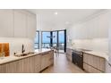 Bright modern kitchen with white countertops, stainless steel appliances and a view of the ocean at 1211 Gulf Of Mexico Dr # 309, Longboat Key, FL 34228