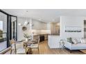 Modern kitchen and dining area with sleek countertops, stainless steel appliances and light wood floors at 1211 Gulf Of Mexico Dr # 309, Longboat Key, FL 34228