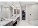 Elegant bathroom with double vanity, granite countertop and a walk-in shower at 13 Bayhead Ln, Osprey, FL 34229
