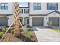Charming townhome features a paver driveway, garage, and landscaped front yard at 14783 Lyla Ter, Bradenton, FL 34211