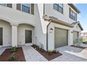 This inviting townhome showcases a well-maintained front yard, dark front door, and attached garage at 14783 Lyla Ter, Bradenton, FL 34211