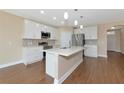 Modern kitchen with white cabinets, stainless steel appliances, and a stylish center island at 15118 Agave Grove Pl, Bradenton, FL 34212