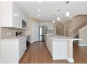 Bright kitchen featuring an island, stainless appliances, and sleek white cabinetry at 15118 Agave Grove Pl, Bradenton, FL 34212