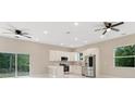 The spacious kitchen boasts modern appliances, a breakfast bar, and easy access to the backyard at 158 Chickering St, Port Charlotte, FL 33954