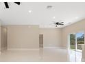 A spacious, light-filled living room provides a comfortable gathering space with backyard access at 158 Chickering St, Port Charlotte, FL 33954