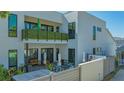 The backyard patio features plenty of seating and a second-story balcony with greenery at 1755 7Th St, Sarasota, FL 34236