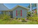 Charming single-story home with red window shutters and well-maintained landscaping at 1765 7Th St, Sarasota, FL 34236