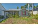 Charming single-story home with red window shutters and a screened porch at 1765 7Th St, Sarasota, FL 34236