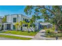 Modern and charming homes side-by-side with palm trees and well-kept lawns at 1765 7Th St, Sarasota, FL 34236