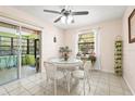 Cozy dining area with a white table, a window view, and access to a sunroom with a sliding door at 18399 Burkholder Cir, Port Charlotte, FL 33948