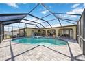 Relaxing screened-in pool area features a heated pool and spa at 19990 Midway Blvd, Port Charlotte, FL 33948