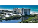 Scenic view of condos with a pond reflecting the building and lush greenery at 20 Whispering Sands Dr # 406, Sarasota, FL 34242