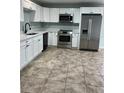 Modern kitchen featuring stainless steel appliances, white cabinets, and stylish countertops at 2510 N Osprey Ave, Sarasota, FL 34234