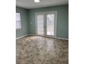 Bright living room featuring tile floors and french doors leading to an outdoor space at 2510 N Osprey Ave, Sarasota, FL 34234