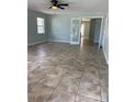 Spacious living room featuring tile floors, ceiling fan, and a pair of french doors at 2510 N Osprey Ave, Sarasota, FL 34234