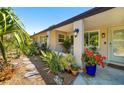 Inviting home exterior featuring lush tropical landscaping and a covered porch at 2610 Jefferson Cir, Sarasota, FL 34239