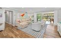 Bright and airy living room with hardwood floors and sliding doors to the outdoors at 2610 Jefferson Cir, Sarasota, FL 34239