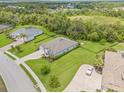 Aerial view of a home featuring lush greenery, well-manicured lawns, and a private backyard at 2707 162Nd E Ave, Parrish, FL 34219