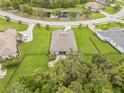 Aerial view of the backyard featuring a landscaped patio with manicured lawn surrounded by trees at 2707 162Nd E Ave, Parrish, FL 34219