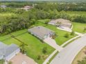 Aerial view of a home with manicured lawn, fenced backyard, and mature trees at 2707 162Nd E Ave, Parrish, FL 34219