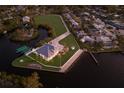 Waterfront estate boasts manicured lawns, private boat dock, and breathtaking water views from an aerial perspective at 327 Riverpoint Ne Dr, Bradenton, FL 34208