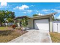 Home featuring an attached garage, landscaped garden, and charming covered entrance at 3828 20Th N St, St Petersburg, FL 33714