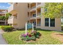 Exterior shot of building with beautifully landscaped entrance featuring colorful flowers and clear signage at 4440 Fairways Blvd # 210, Bradenton, FL 34209