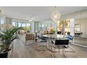 Bright and airy living room featuring contemporary furniture, mirrored wall, and golf course views at 4440 Fairways Blvd # 210, Bradenton, FL 34209