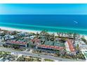 Aerial image of condos situated along the beach, with tennis courts and ocean views at 5055 Gulf Of Mexico Dr # 422, Longboat Key, FL 34228