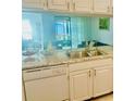 Kitchen showcasing stainless steel sink, granite countertops, and white cabinetry at 5061 Barrington Cir # 1302, Sarasota, FL 34234