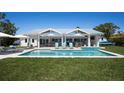 A refreshing pool with cozy lounge chairs and outdoor seating, perfect for enjoying sunny days and relaxation at 527 Key Royale Dr, Holmes Beach, FL 34217