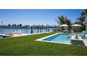 Serene waterfront pool with views of the canal and a private dock at 527 Key Royale Dr, Holmes Beach, FL 34217
